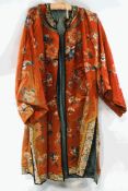 An early 20th century Chinese silk jacket, embroidered with flowers, fruit and bats,