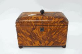 A George III tortoiseshell tea caddy, with twin lidded compartments, one with glass liner,