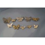 A collection of ten butterfly brooches, in various metals,