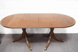 A Regency style mahogany twin pedestal dining table, with one additional leaf,