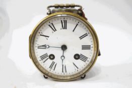 A brass cased drum clock with visible escapement, striking on a bell, with winding key,