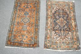 A small Persian rug, with stylised floral motifs to central field on a beige ground,