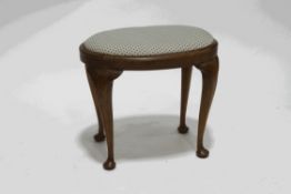 A 19th century oval walnut stool, with patterned upholstered seat,
