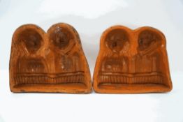 A pair of terracotta moulds, each with two figures, 22cm high x 26.