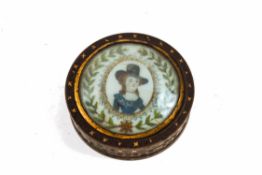 An early 18th century circular lacquered snuffbox, the lid inset with a portrait of a lady,