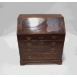 A George III mahogany bureau, the fall front enclosing a fitted interior with drawers,