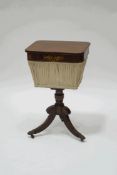 A Regency rosewood and brass inlaid work table, on outswept legs and brass lion's paw feet,