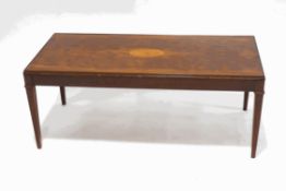 A mahogany coffee table with marquetry rosette, on square tapering legs,