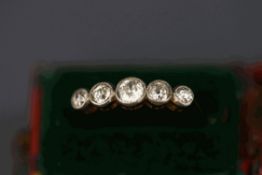 A five stone diamond ring, indistinctly stamped,