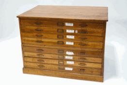 An oak two part plan chest with eight drawers on plinth base,