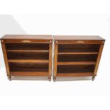 A pair of mahogany bookcases, each with two adjustable shelves, on turned legs,