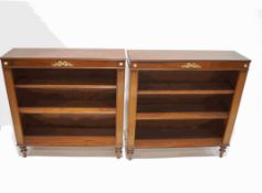 A pair of mahogany bookcases, each with two adjustable shelves, on turned legs,