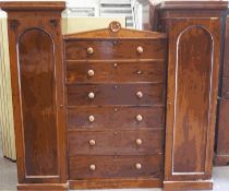 A Victorian sectional mahogany wardrobe, with central chest of six drawers,