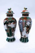 A pair of Chinese famille verte porcelain vases and covers, of baluster form,