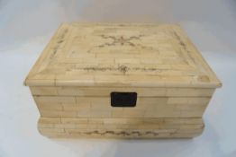 A Mammoth ivory box , the lid decorated with penwork scrolls and flowers,