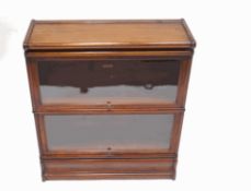 A Globe Wernicke mahogany bookcase, comprising a base, two tiers and a top, with labels to back,