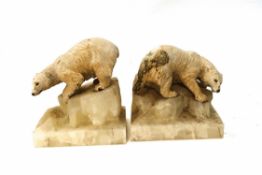 A pair of Art Deco bookends, modelled as cold painted bronze polar bears upon marble bases,
