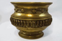 A brass embossed jardiniere, of round form with flared foot, 30.