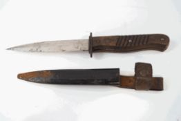 A WWII German trench knife with wooden handle and metal sheath,
