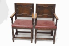 A pair of oak elbow chairs with leatherette seats,