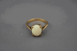 A 9 carat gold single stone opal ring, finger size O, 2.