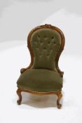 A Victorian walnut framed button back nursing chair, with green upholstery,