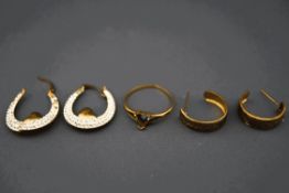 A 9 carat gold ring with vacant setting; a pair of paste set hoop earrings,