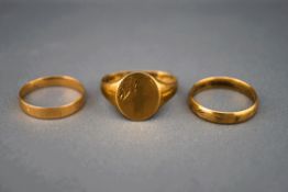 A 9 carat gold signet ring; and two 9 carat gold wedding rings; 5.