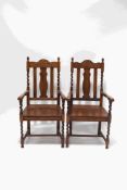A pair of oak elbow chairs with barley twist supports and legs finished by H stretchers,