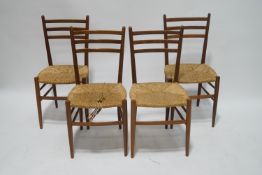 A set of four teak 1960's ladderback chairs, each with rush seats,