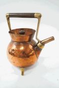 A Christopher Dresser style brass and copper teapot on three splayed legs,