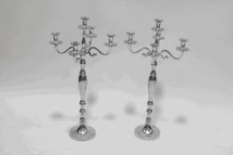 A pair of five branch aluminium candelabras on baluster stems and flared bases,