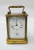 A large brass carriage clock with alarm, striking on a bell, 16cm high (handle up),