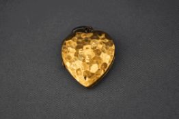 A 9 carat gold locket, of heart shape with a hammered effect finish, 2.