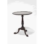 A George III style mahogany tilt top table, the piecrust top upon a turned column and claw feet,