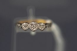 A three stone diamond ring, stamped '18ct lat',