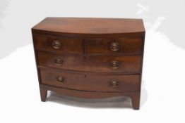 A George III mahogany bow fronted chest of two short and two long drawers with shaped apron and