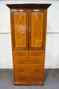 An Edwardian mahogany and inlaid cupboard over five drawers, on plinth base,