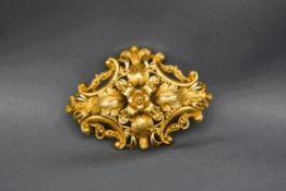 A Victorian gold brooch, unmarked, with leaf and scrolls, 4.6 cm across, 9.