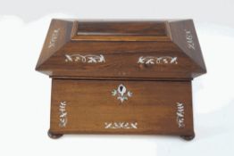 A 19th century rosewood and mother of pearl inlaid tea caddy, of sarcophagus form,