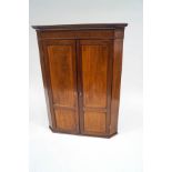 A 19th century mahogany corner cupboard with satinwood stringing and ivory escutcheons,
