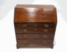 A George III mahogany bureau, the fall front enclosing a pigeon hole interior and drawers,