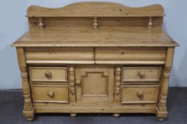 A Victorian pine sideboard, two large drawers above a central cupboard and four short drawers,
