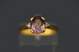 An 18 carat amethyst and diamond three stone ring, finger size N, 3.
