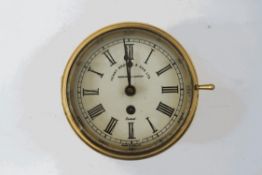 A brass ships bulkhead clock, Henry Brown and Sons (with key),
