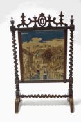 A Victorian rosewood firescreen with tapestry panel of a Continental town and river scene,