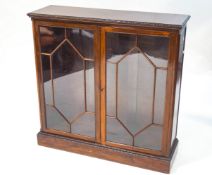 An Edwardian mahogany bookcase with two glazed doors,