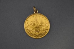 A yellow metal Turkish coin, mounted as a pendant with a soldered ring, 7.