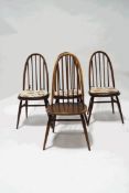 A set of four Ercol stick back kitchen chairs and an oak drawleaf refectory style dining table,