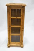 A pine standing display cabinet with glazed panelled doors and split mouldings, 166.